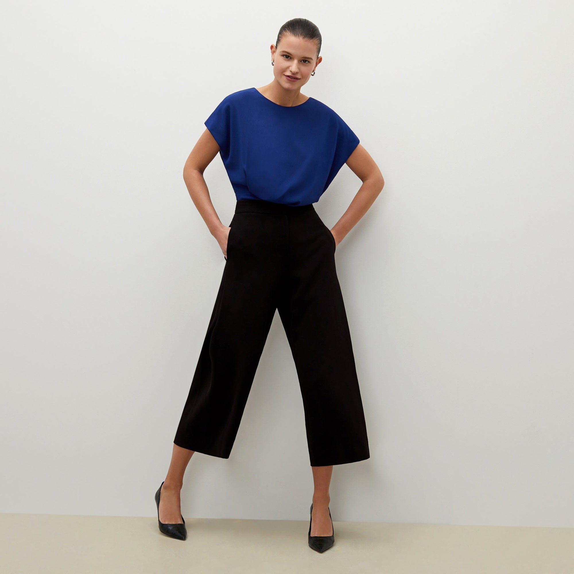 Front image of a woman standing wearing the Zhou culotte in black | Exclude
