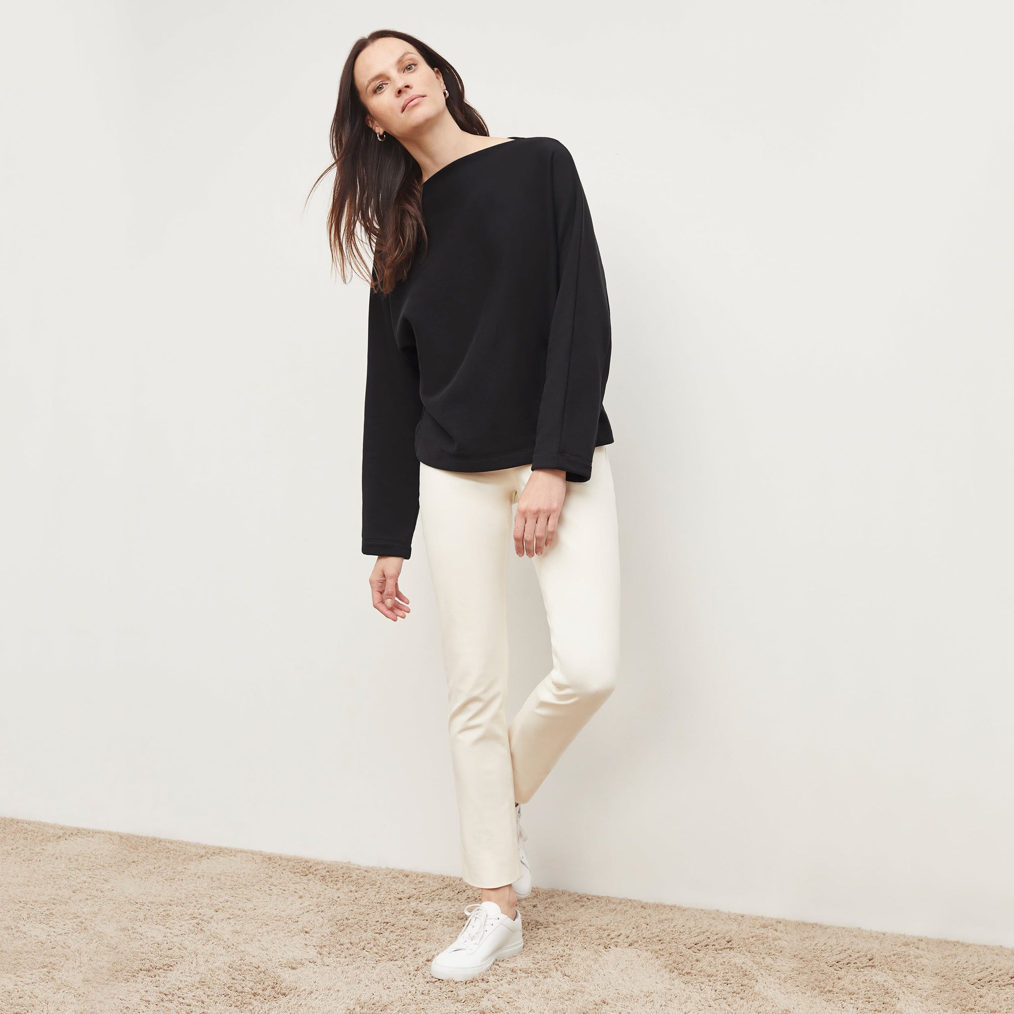 Front image of a woman standing wearing the foster pant in bone