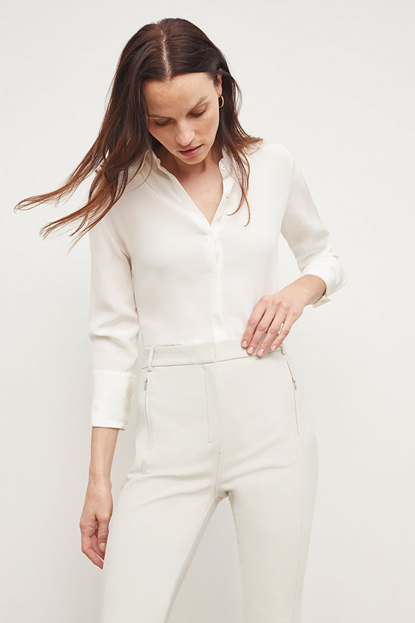 Front image of a woman standing wearing the Curie Pant—Everstretch in Bone | Grid Hover | Exclude