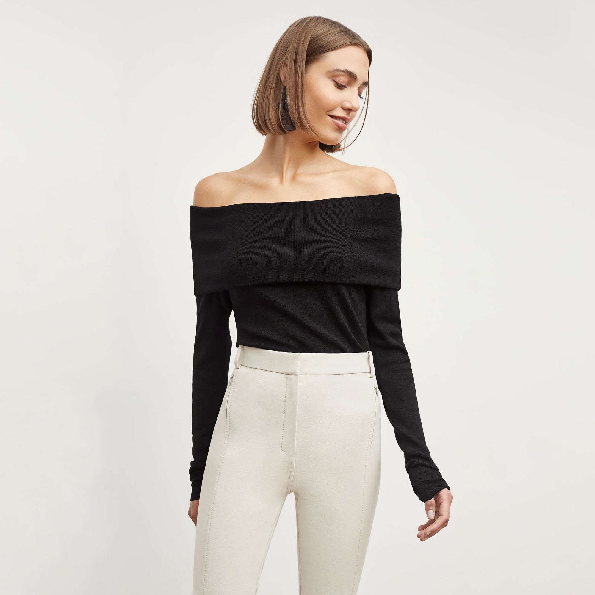Front image of a woman standing wearing the Curie Pant—Everstretch in Bone | Exclude