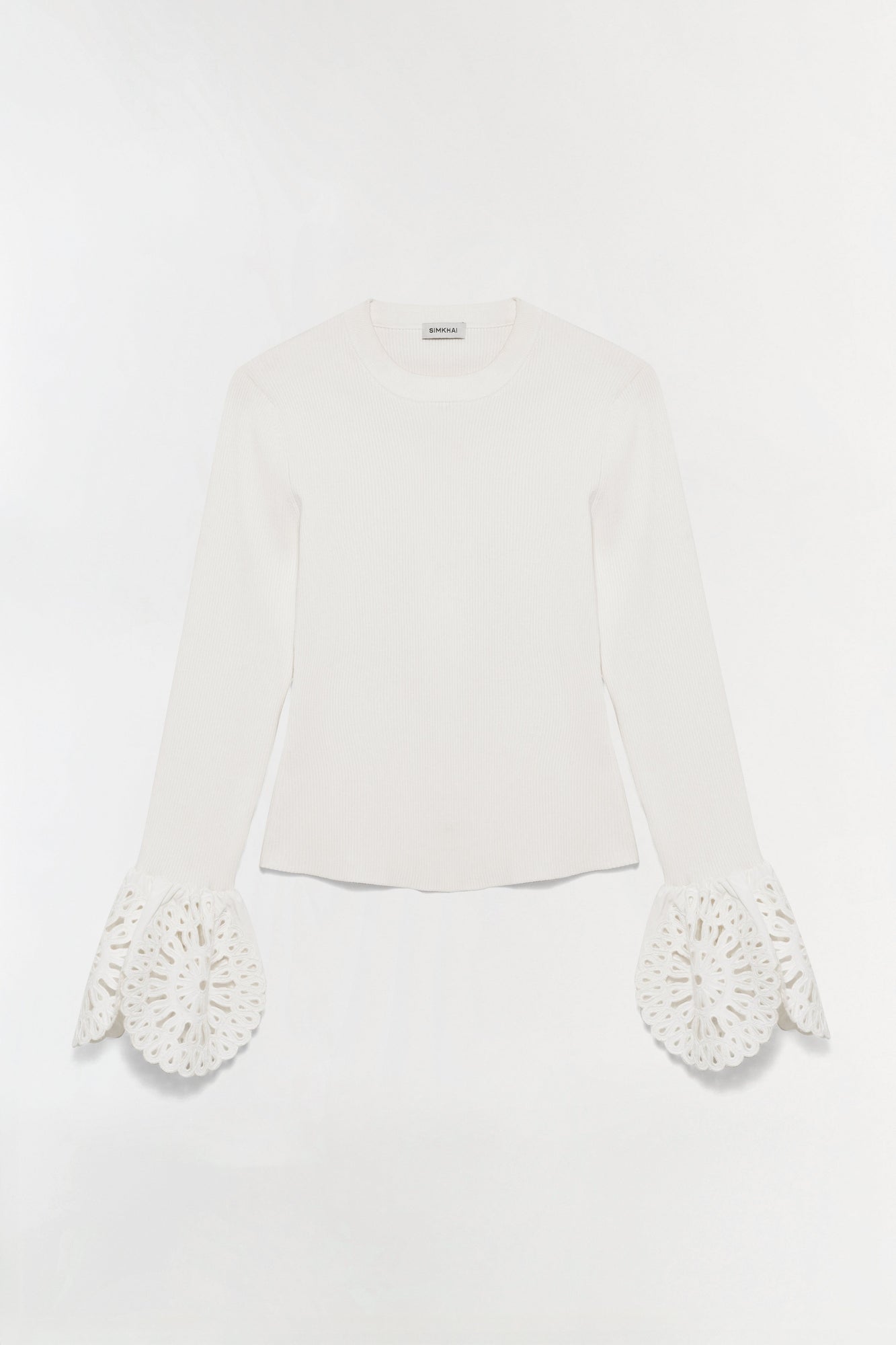 Cream ribbed knit top with long sleeves featuring openwork embroidered cuffs in a scalloped petal design.