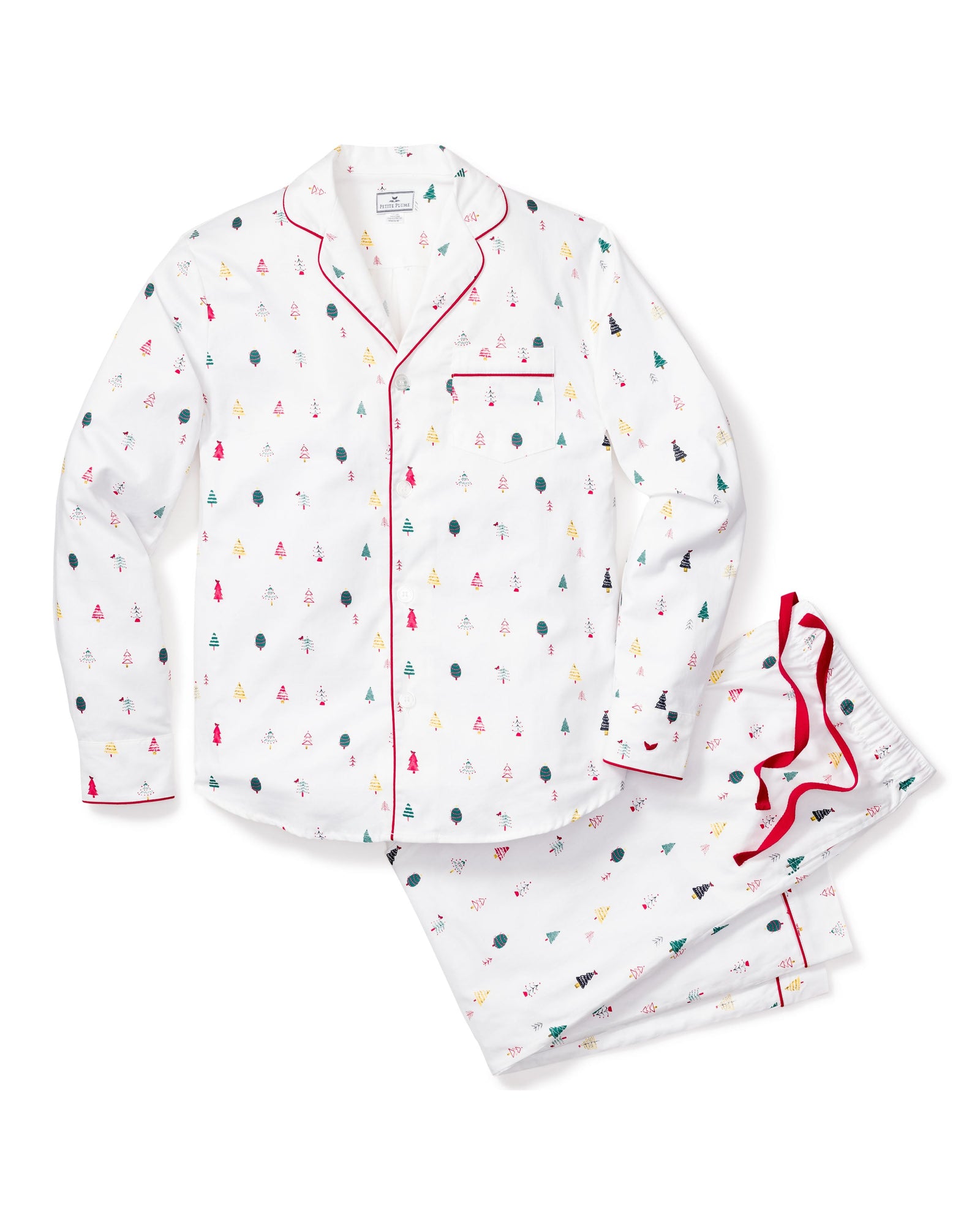 The Mens Twill Pajama Set in Merry Trees by Petite Plume includes a white button-up shirt and pants made from top-quality cotton, featuring small red, green, and black tree patterns. The shirt has a chest pocket and red piping, while the pants offer an elastic waistband for comfort—perfect for Christmas.