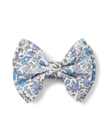 The Girls Twill Hair Bows in Fleur DAzur by Petite Plume is a charming accessory featuring a floral pattern in shades of blue and gray on a light background.