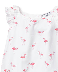 The Girls Twill Amelie Short Set by Petite Plume features a white sleeveless pajama dress with ruffled shoulders and charming small pink flamingos, offering a whimsical touch of comfort.