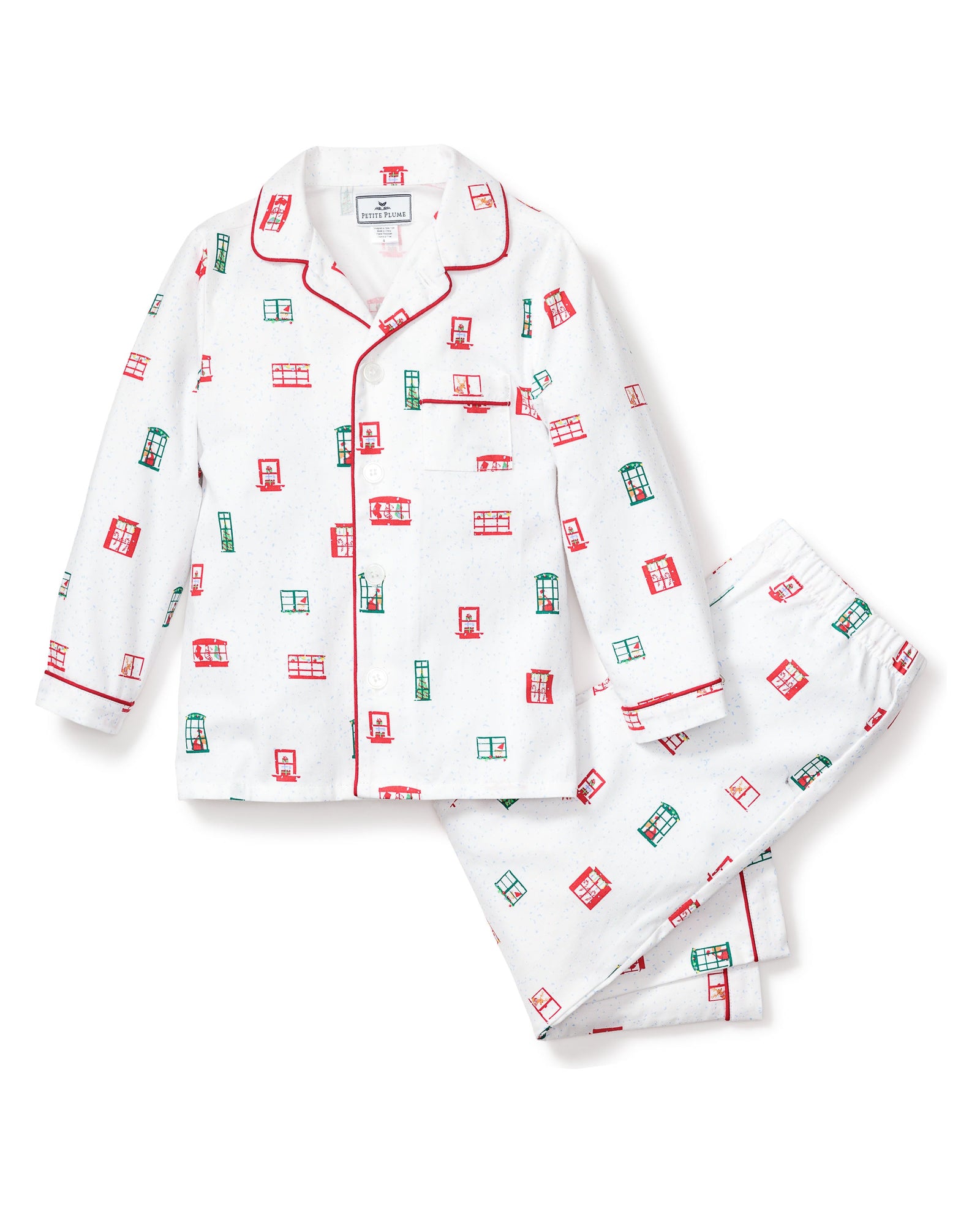 The Kids Maisonette x Petite Plume Night Before Pajama Set by Petite Plume is a classic twill sleepwear featuring a button-up shirt and pants with red and green geometric patterns, a collar, and red piping details inspired by the Night Before Christmas print.