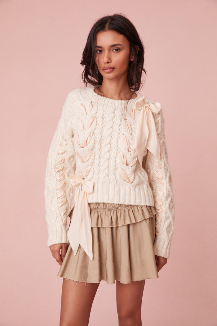 Sweater with chunky Peruvian cable detailing and a charmeuse ribbon threaded throughout.