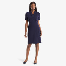 Front image of a woman standing wearing theTory Dress in dark iris | Lead