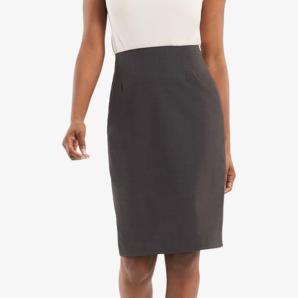 Grid image of a woman standing wearing the Cobble Hill skirt in gray melange. | Exclude