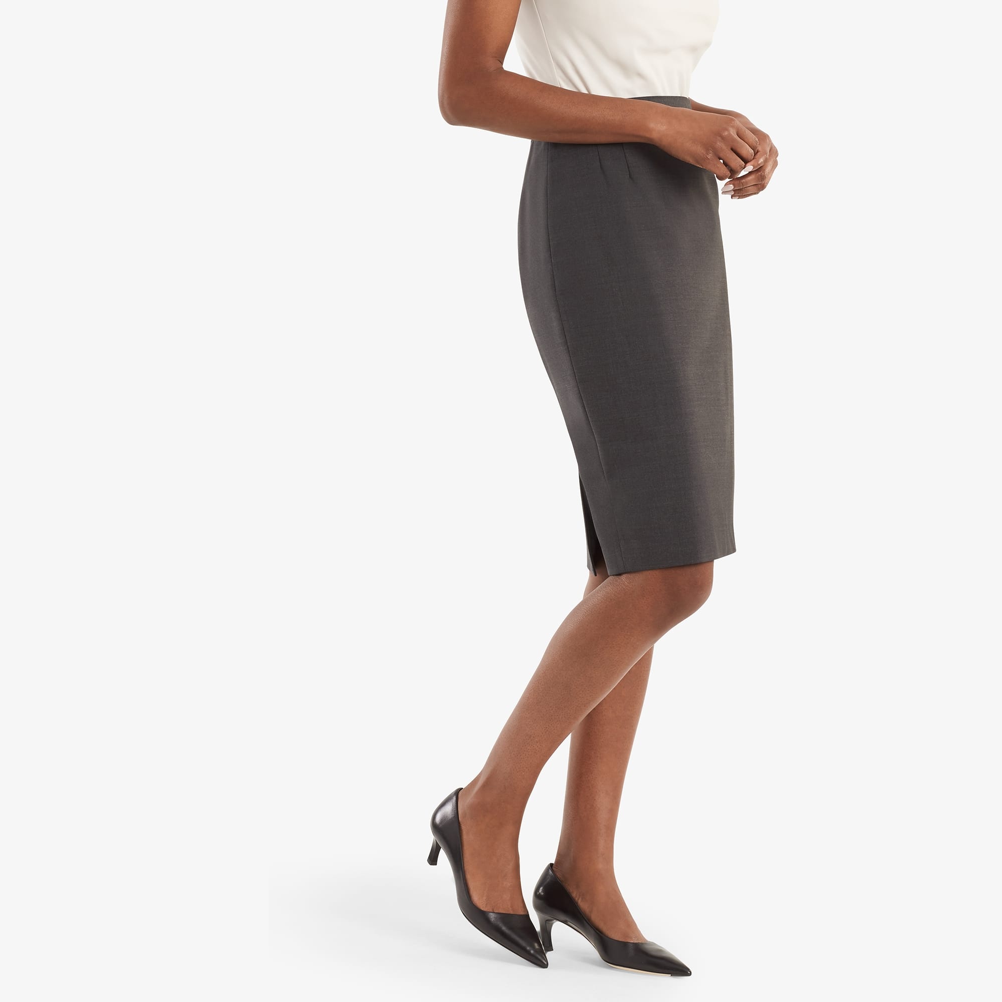 Side image of a woman standing wearing the Cobble Hill skirt in gray melange. | Exclude
