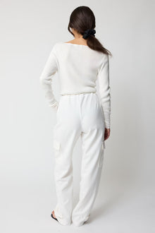 Person wearing a white outfit on a plain background