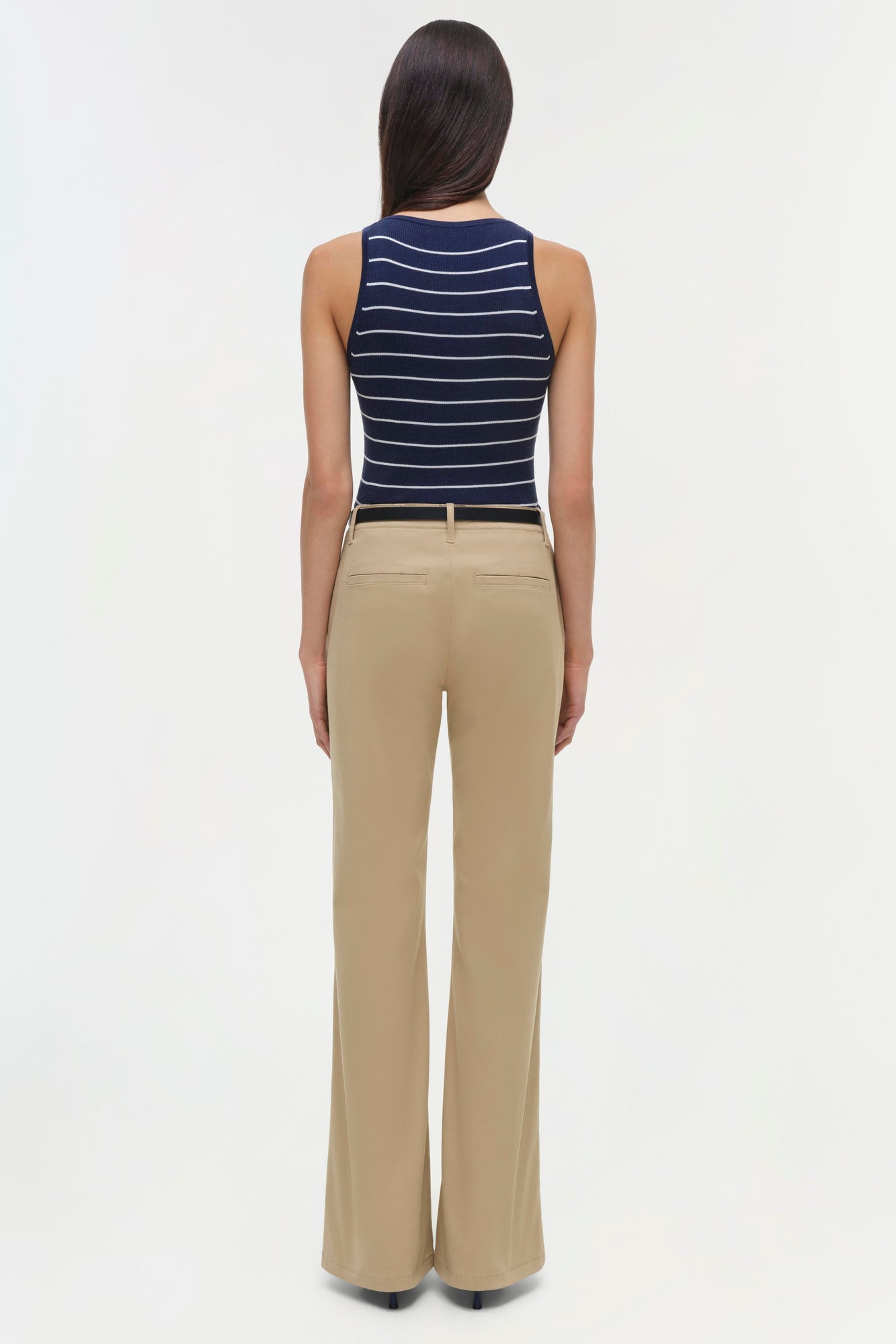 Beige wide-leg trouser with belt loops, shown from back on model wearing navy striped tank top.
