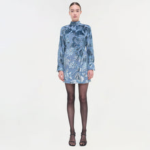 Blue floral printed dress with long sleeves, mock neckline, and A-line silhouette.