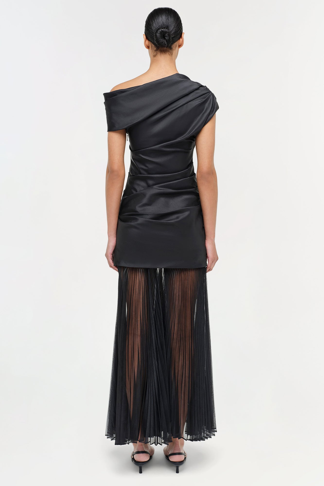 Black off-shoulder midi dress with ruched bodice and pleated sheer skirt with side slit.