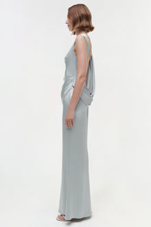 Gray sleeveless floor-length gown with draped back detail, shown from side view on model.