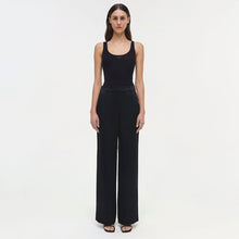Black wide-leg pants with a high waist and straight silhouette, paired with a sleeveless black top.