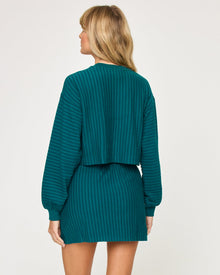 Back view of model wearing the Half Court Pullover in deep teal with matching deep teal Half Court Skirt.