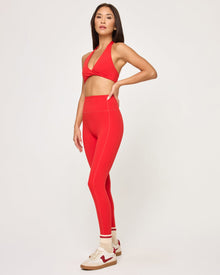 Side view of model wearing the Jeanne Bra in flame with matching flame Level Up Legging.