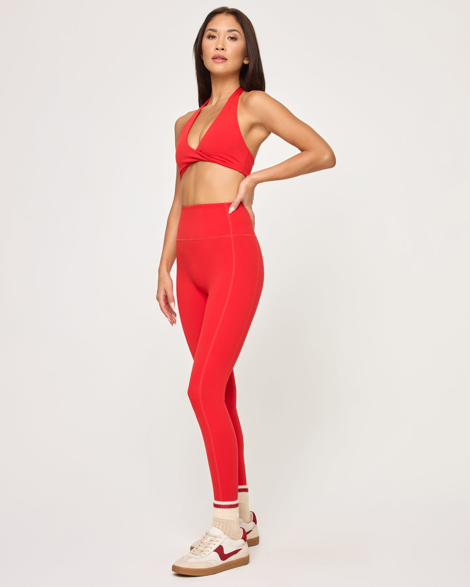 Side view of model wearing the Jeanne Bra in flame with matching flame Level Up Legging.
