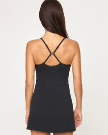 Close-up back view of model wearing the Kelsey Dress in black showing the crossback strap configuration.