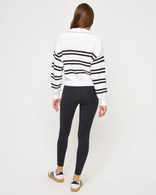 Back view of the LSPACE Ultra Stripe Sweater in black-white on a model, showing the back of the ribbed sweater with bold black and white horizontal stripes.