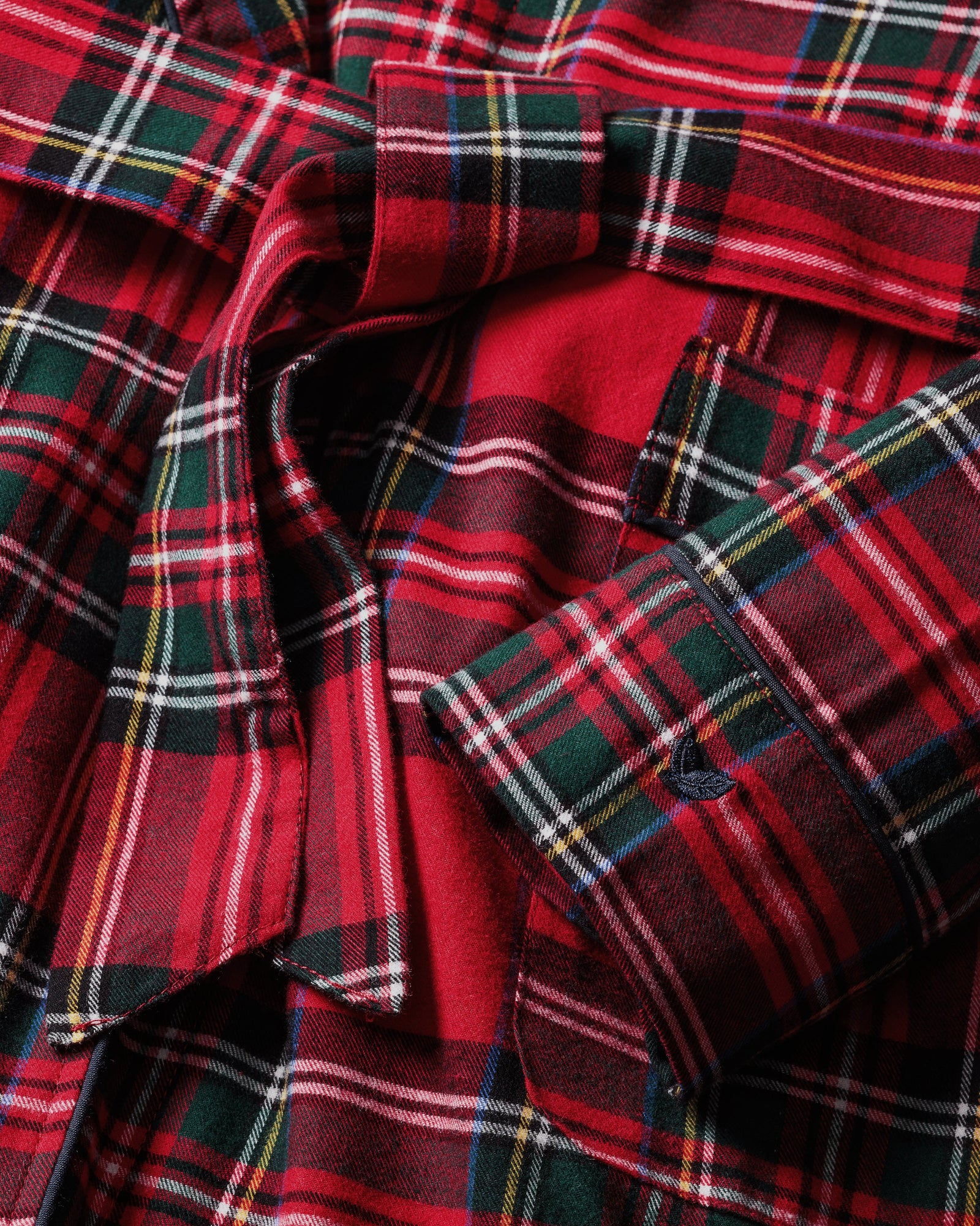 The Women's Brushed Twill Robe in Imperial Tartan features a red plaid pattern, long sleeves, a shawl collar, front pockets, and a matching waist tie, shown flat on a white background.