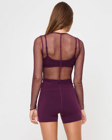 Back studio view of the Zani Top in plum, a plum-colored ribbed sleeveless tank top.