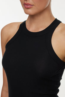 Model wears a high neck black tank. 