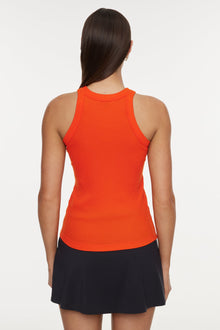 Model wears a high neck bright orange tank top. 