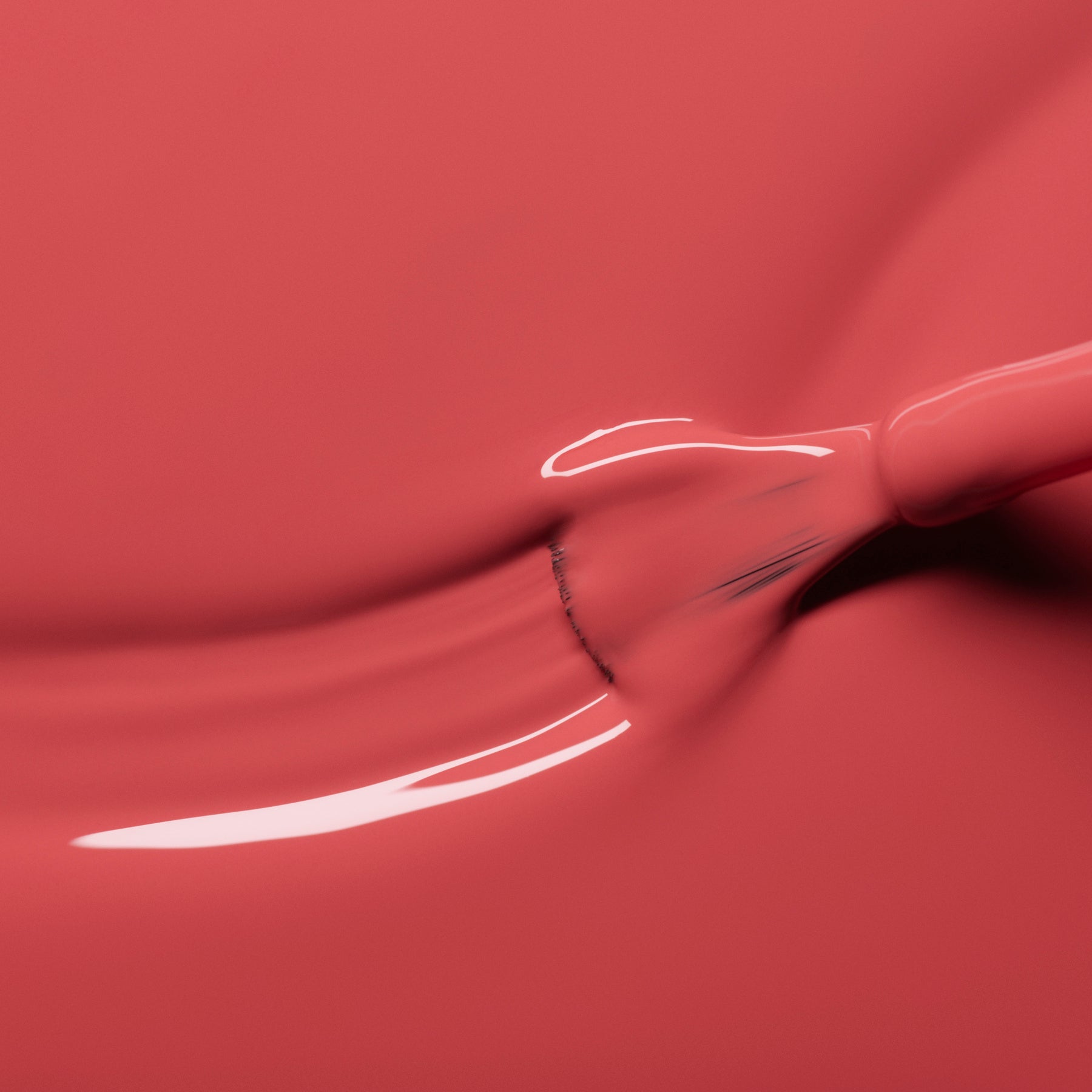 A close-up of a brush spreading glossy pink nail polish, creating smooth, fluid lines and a reflective surface.