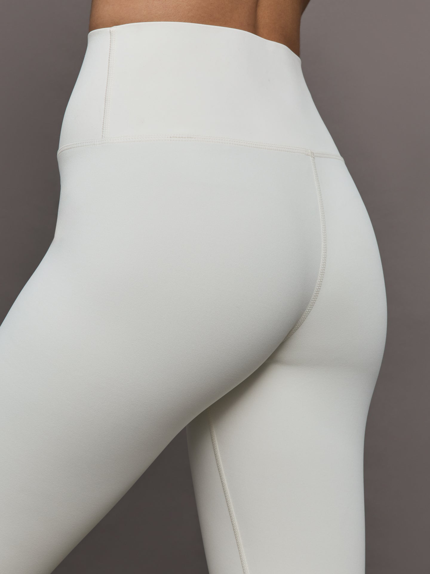 Model wears a highly compressive white high waisted legging. 