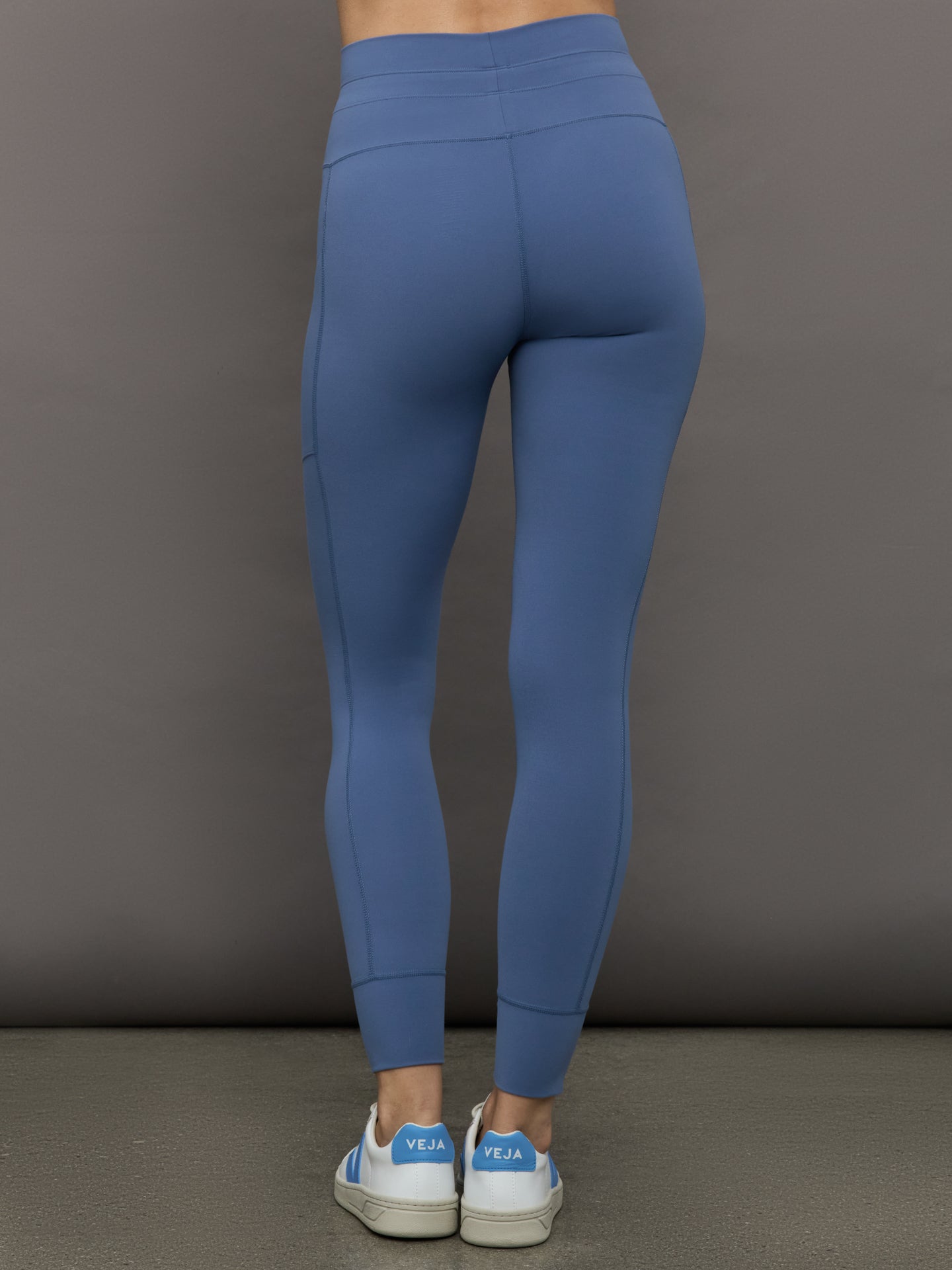 Model wears a periwinkle blue buttery soft pair of leggings with pockets and drawstring waist, perfect for all activities. 
