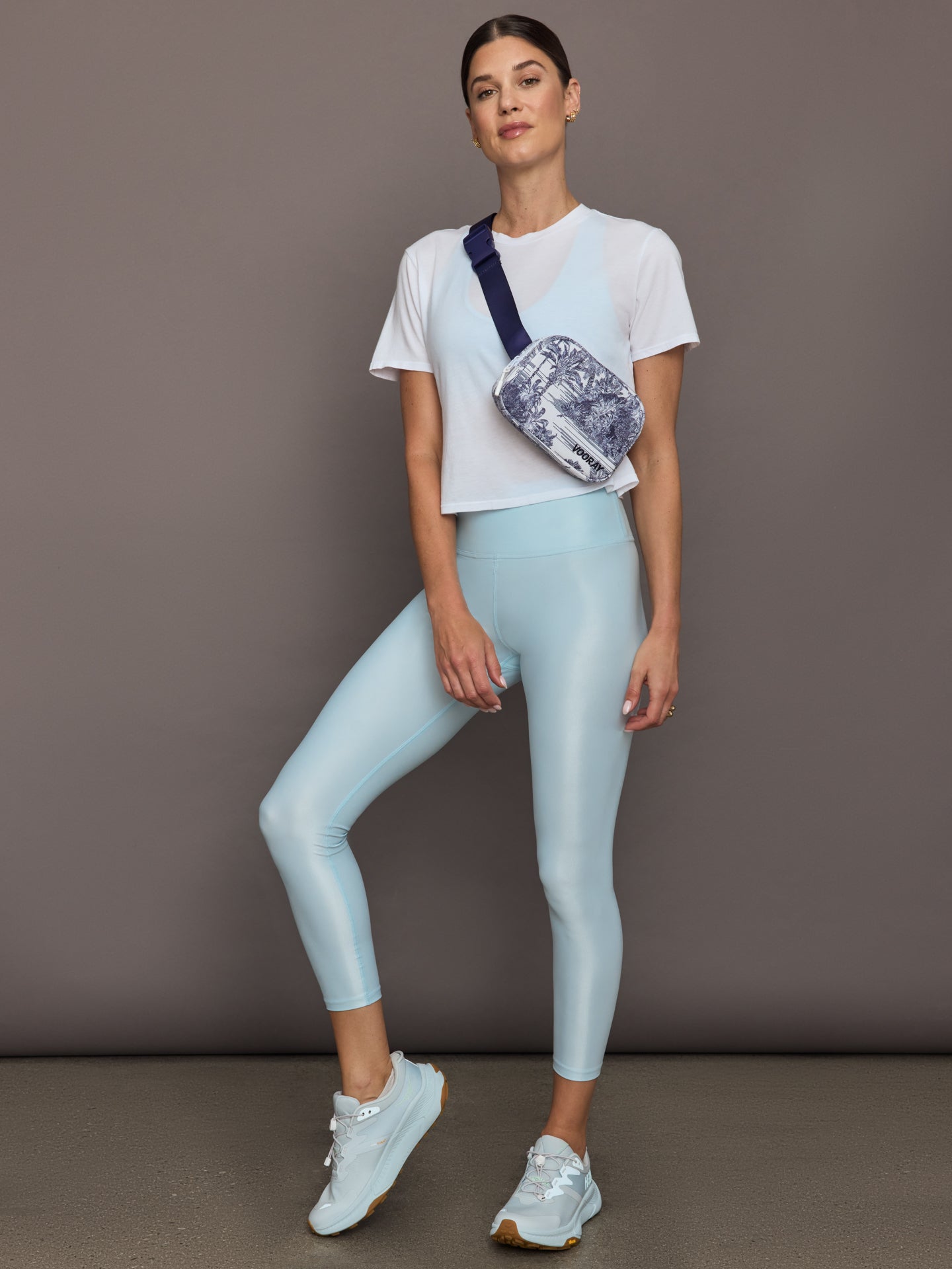 Model wears a cropped boxy white sheer tee shirt. 