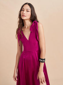 Be a vision in this softer than silk dress featuring adjustable ties at the shoulder and a smocked back for ease. Don't worry, we didn't forget the pockets on this one, cleverly hidden in the contrast matte lining which flares out with movement.