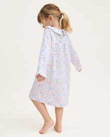 The Kid's Twill Scarlett Nightgown in Baking Spirits Bright features long sleeves, a ruffled collar and cuffs, and a pastel cupcake, teapot, and cutlery print on a white background.