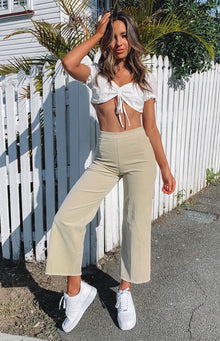 Beige corduroy high-waisted wide-leg pants with a raw hem and front seam detail
