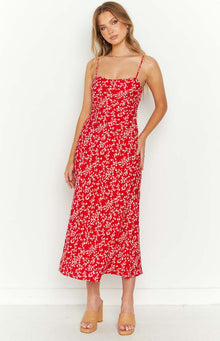 Side view of a red floral midi dress with spaghetti straps and a cutout waist detail