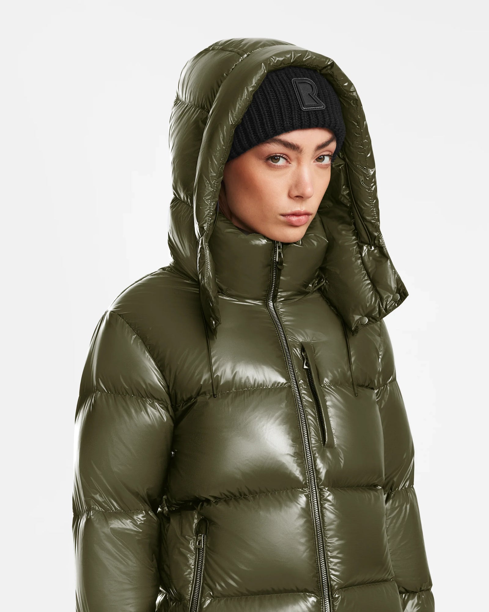 A woman in a Rudsak ASHLYN S - 8124565 Loden Green down puffer coat.