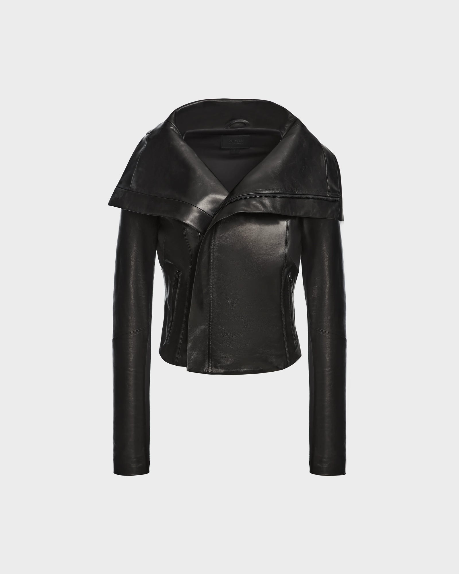 The AVRIL - 8124561 Black womens leather jacket by Rudsak features a wide asymmetrical lapel and fitted sleeves, showcased on a plain white background.
