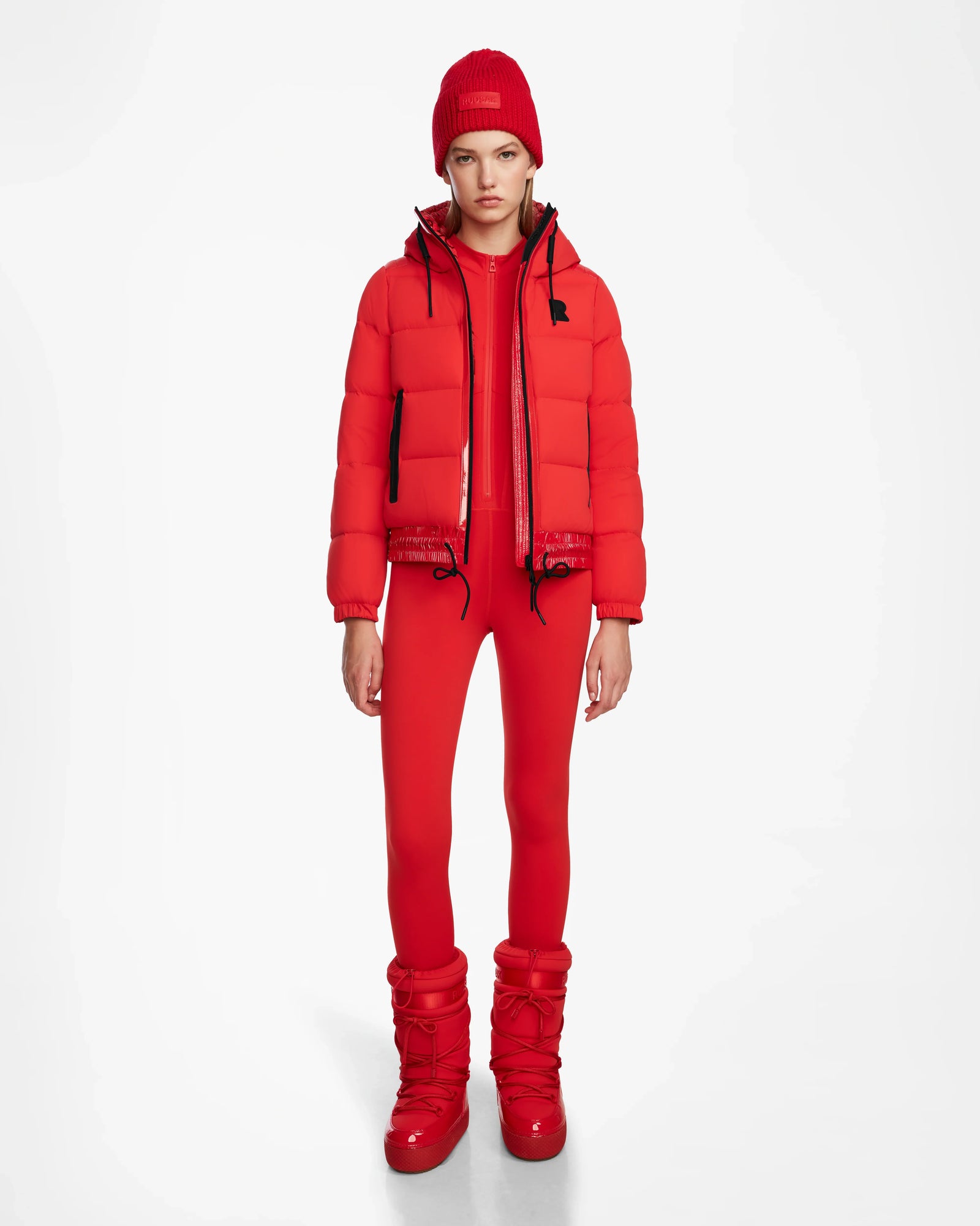 A woman wearing the Rudsak DANI M - 8124539 Flame Red faux teddy ski jacket.