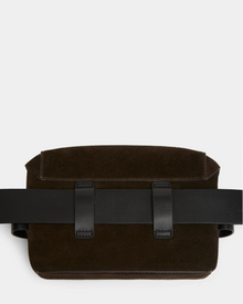 The Rudsak OFILIA S - 8324521 Espresso is a dark brown suede crossbody belt bag with a flap closure and two black leather straps across the front, shown against a plain white background.