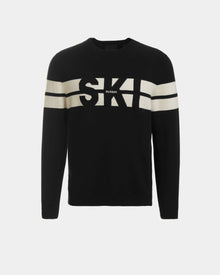 The OMAR - 6523507 Black by Rudsak is a men’s black crewneck sweater with white chest and sleeve stripes, bold “SKI” lettering, and subtle Rudsak branding—ideal for stylish après-ski gatherings.