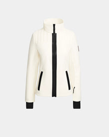 The Rudsak ROSALIE - 8124784 Iceland is a women's fitted white ski jacket with a high collar, black front zipper, zippered side pockets, and cuff accents. Displayed on a light gray background. Features RECCO rescue technology for safety.