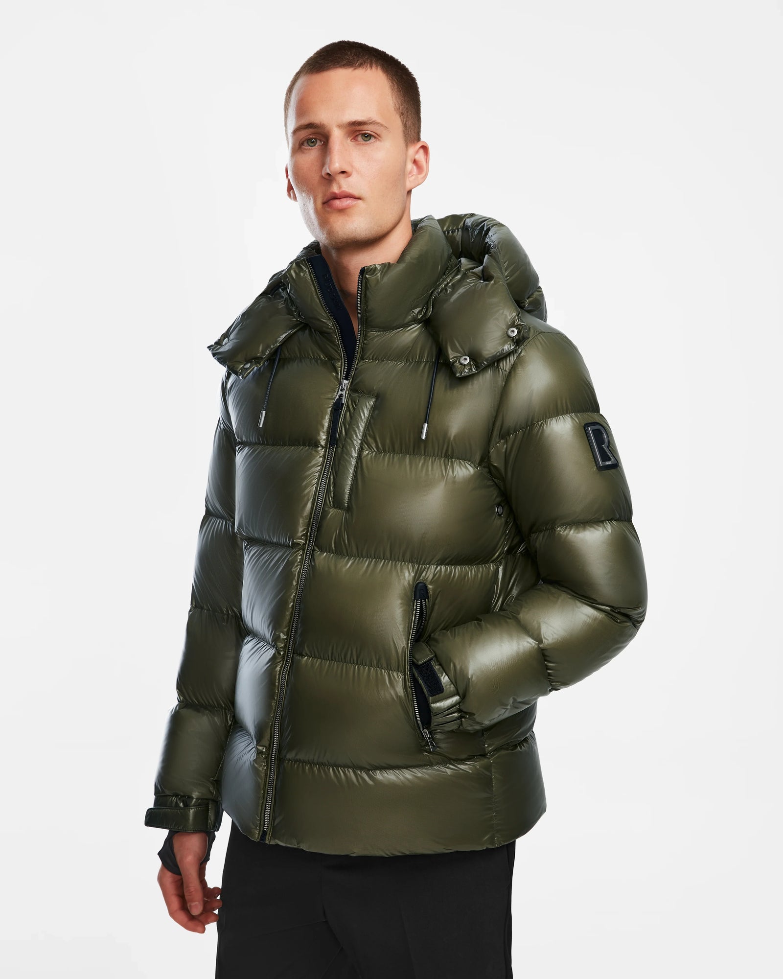 A man in a Rudsak VINCE S - 6124560 Loden Green down puffer coat.