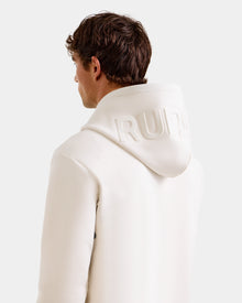 A person with short brown hair, seen from behind, wears the Rudsak LEROY - U525509 Vanilla M hoodie with the hood up, featuring embossed 