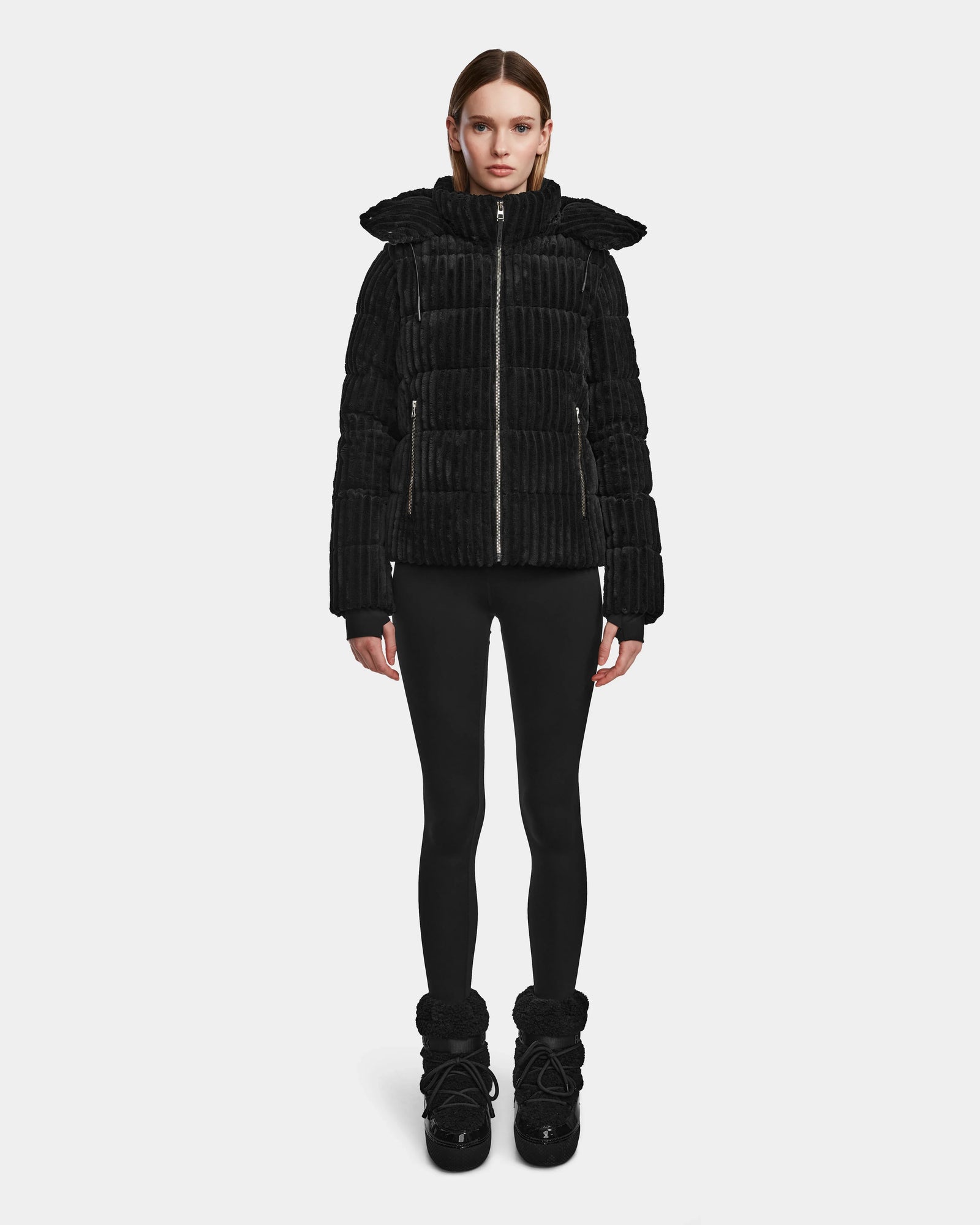 A woman faces forward wearing the MIRRY FF - L124507 Black women’s short down puffer jacket with a hood, black leggings, and black winter boots against a plain white background. The jacket features RDS-certified down for warmth and comfort.