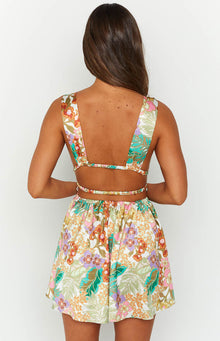 Close-up of the shirred waist and side cutouts on a tropical floral mini dress