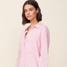 Close up view of model wearing the linen shirt dress in bubblegum.