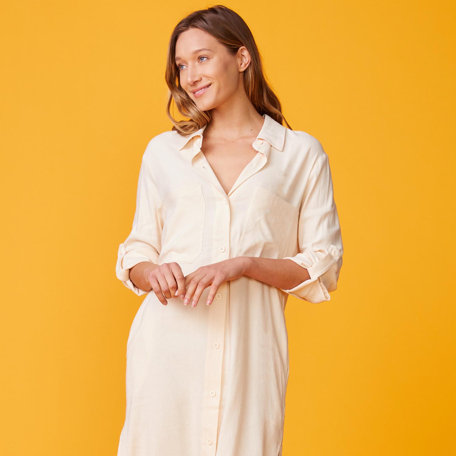 Front view of model wearing the linen shirt dress in buttercream.