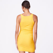 Back view of model wearing the rib square neck mini dress in marigold.