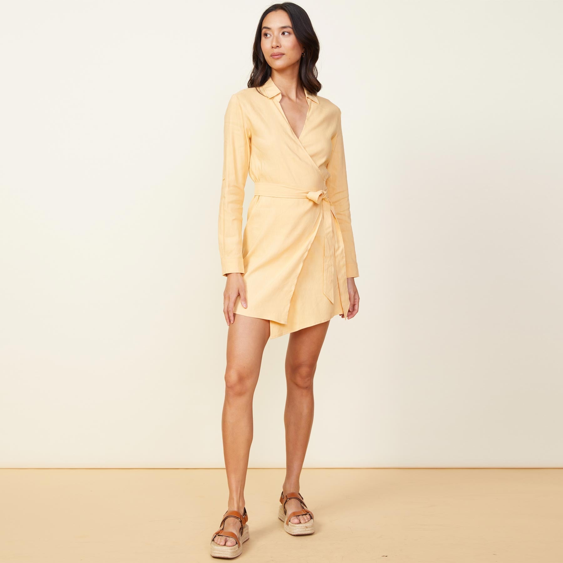 Front view of model wearing the linen mini dress in sand.